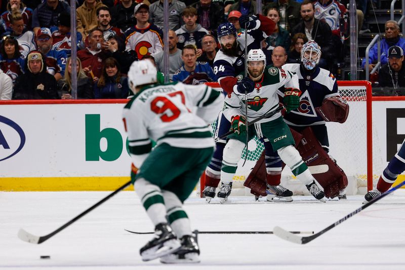 Mar 8, 2026; Denver, Colorado, USA; Colorado Avalanche defenseman Brent Burns (84) and Minnesota Wild right wing Ryan Hartman (38) battle for position in front of goaltender Scott Wedgewood (41) as left wing Kirill Kaprizov (97) controls the puck in the second period at Ball Arena. Mandatory Credit: Isaiah J. Downing-Imagn Images
