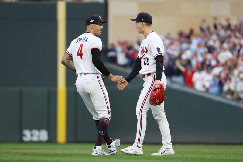 Oct 4, 2023; Minneapolis, Minnesota, USA; Minnesota Twins shortstop Carlos Correa (4) and relief pitcher Griffin Jax (22) celebrated play in the eighth inning against the Toronto Blue Jays  during game two of the Wildcard series for the 2023 MLB playoffs at Target Field. Mandatory Credit: Jesse Johnson-USA TODAY Sports