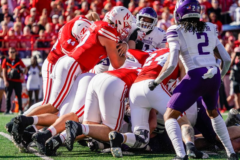 Oct 21, 2023; Lincoln, Nebraska, USA; Nebraska Cornhuskers quarterback Heinrich Haarberg (10) runs the ball out of the end zone after starting one the 1-yard line against the Northwestern Wildcats during the first quarter at Memorial Stadium. Mandatory Credit: Dylan Widger-USA TODAY Sports