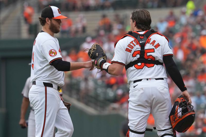 Jun 13, 2024; Baltimore, Maryland, USA; Baltimore Orioles pitcher Cole Irvin (19) greeted by catcher Adley Rutschman (35) after the first inning against the Atlanta Braves at Oriole Park at Camden Yards. Mandatory Credit: Mitch Stringer-USA TODAY Sports