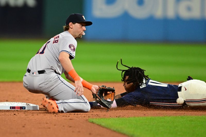 Sep 27, 2024; Cleveland, Ohio, USA; Houston Astros shortstop Grae Kessinger (11) waits for the throw as Cleveland Guardians third baseman Jose Ramirez (11) steals second base during the first inning at Progressive Field. Mandatory Credit: Ken Blaze-Imagn Images