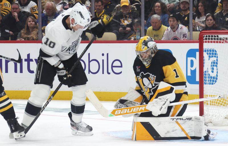 Nov 9, 2025; Pittsburgh, Pennsylvania, USA;  Pittsburgh Penguins goaltender Sergei Murashov (1) makes a save against Los Angeles Kings right wing Corey Perry (10) during the second period at PPG Paints Arena. Mandatory Credit: Charles LeClaire-Imagn Images