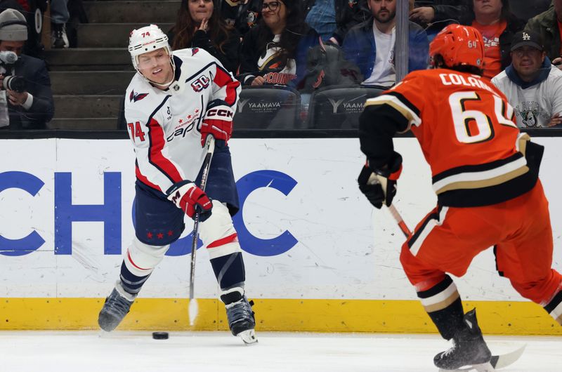 Mar 11, 2025; Anaheim, California, USA; Washington Capitals defenseman John Carlson (74) shoots against Anaheim Ducks right wing Sam Colangelo (64) during the first period at Honda Center. Mandatory Credit: Jason Parkhurst-Imagn Images