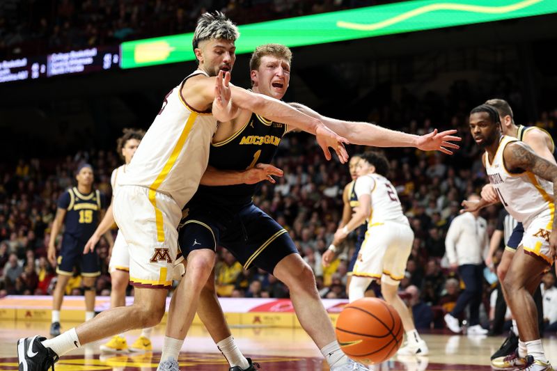 Jan 16, 2025; Minneapolis, Minnesota, USA; Minnesota Golden Gophers forward Dawson Garcia (3) steals the ball from Michigan Wolverines center Danny Wolf (1) during the second half at Williams Arena. Mandatory Credit: Matt Krohn-Imagn Images