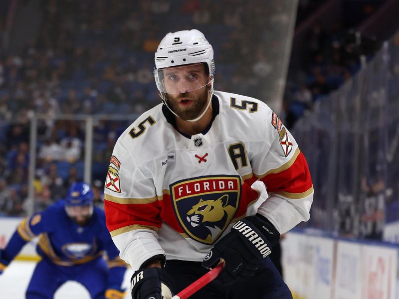 Oct 28, 2024; Buffalo, New York, USA;  Florida Panthers defenseman Aaron Ekblad (5) goes after a loose puck during the second period against the Buffalo Sabres at KeyBank Center. Mandatory Credit: Timothy T. Ludwig-Imagn Images