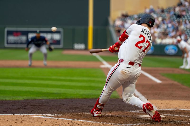 Jun 24, 2025; Minneapolis, Minnesota, USA; Minnesota Twins catcher Ryan Jeffers (27) hits a two-run double against the Seattle Mariners in the fourth inning at Target Field. Mandatory Credit: Jesse Johnson-Imagn Images