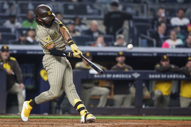 May 6, 2025; Bronx, New York, USA;  San Diego Padres right fielder Fernando Tatis Jr. (23) hits a two run double in the seventh inning against the New York Yankees at Yankee Stadium. Mandatory Credit: Wendell Cruz-Imagn Images