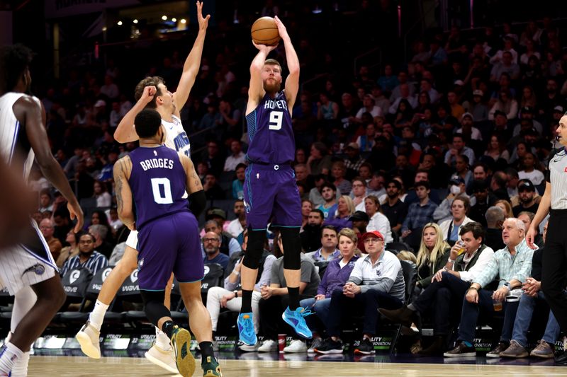 CHARLOTTE, NORTH CAROLINA - MARCH 05: Davis Bertans #9 of the Charlotte Hornets shoots a three pointer during the first half of an NBA game against the Orlando Magic at Spectrum Center on March 05, 2024 in Charlotte, North Carolina. NOTE TO USER: User expressly acknowledges and agrees that, by downloading and or using this photograph, User is consenting to the terms and conditions of the Getty Images License Agreement. (Photo by David Jensen/Getty Images)