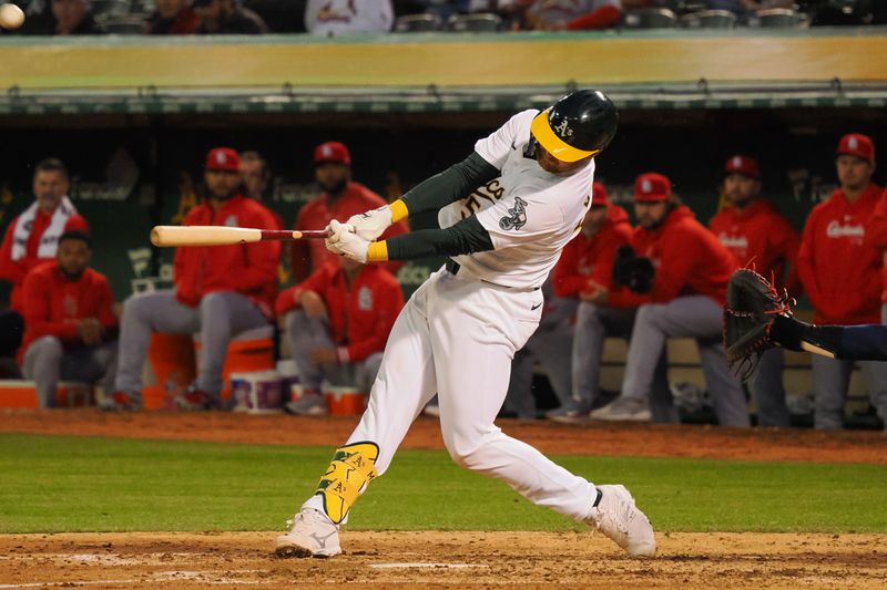 Apr 16, 2024; Oakland, California, USA; Oakland Athletics catcher Kyle McCann (52) hits a solo home run against the St. Louis Cardinals during the fifth inning at Oakland-Alameda County Coliseum. Mandatory Credit: Kelley L Cox-USA TODAY Sports