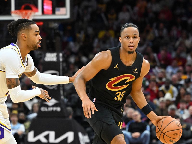 CLEVELAND, OHIO - NOVEMBER 25: Isaac Okoro #35 of the Cleveland Cavaliers brings the ball up court around D'Angelo Russell #1 of the Los Angeles Lakers during the third quarter at Rocket Mortgage Fieldhouse on November 25, 2023 in Cleveland, Ohio. The Lakers defeated the Cavaliers 121-115. NOTE TO USER: User expressly acknowledges and agrees that, by downloading and or using this photograph, User is consenting to the terms and conditions of the Getty Images License Agreement. (Photo by Jason Miller/Getty Images)