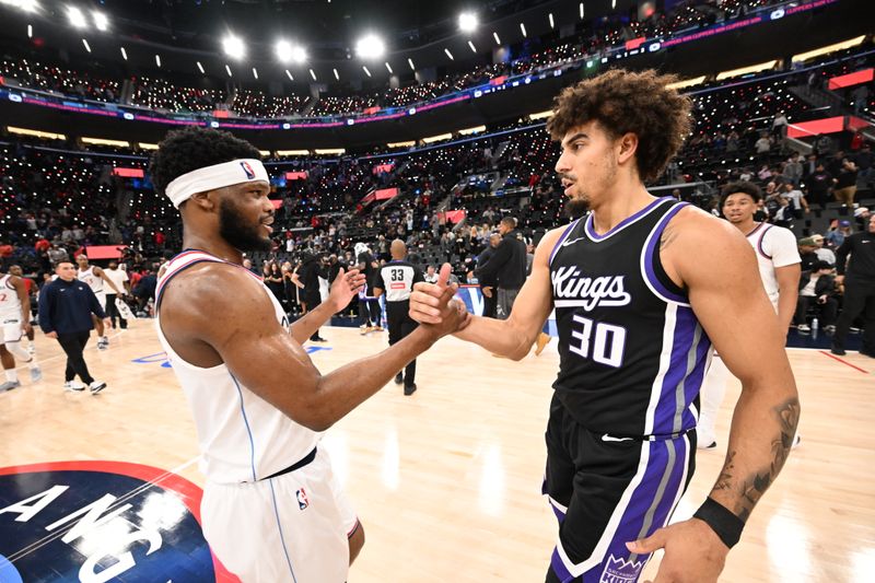 INGLEWOOD, CA - OCTOBER 17: Elijah Harkless #15 of the LA Clippers and Brodric Thomas #30 of the Sacramento Kings high five after the game during a NBA Preseason game on October 17, 2024 at Intuit Dome in Los Angeles, California. NOTE TO USER: User expressly acknowledges and agrees that, by downloading and/or using this Photograph, user is consenting to the terms and conditions of the Getty Images License Agreement. Mandatory Copyright Notice: Copyright 2024 NBAE (Photo by Adam Pantozzi/NBAE via Getty Images)