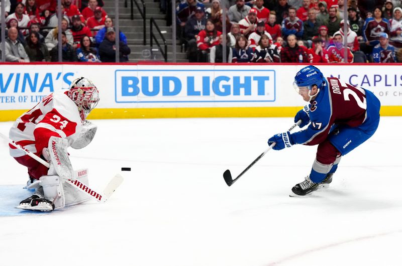 Mar 6, 2024; Denver, Colorado, USA; Colorado Avalanche left wing Jonathan Drouin (27) shoots the puck on Detroit Red Wings goaltender Alex Lyon (34) in the second period at Ball Arena. Mandatory Credit: Ron Chenoy-USA TODAY Sports