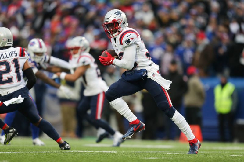 FILE - New England Patriots safety Devin McCourty (32) returns an interception during the first half of an NFL football game against the Buffalo Bills on Sunday, Jan. 8, 2023, in Orchard Park, N.Y. McCourty is retiring from the NFL, ending a 13-year run with the team that included winning three Super Bowl rings.(AP Photo/Joshua Bessex, File)