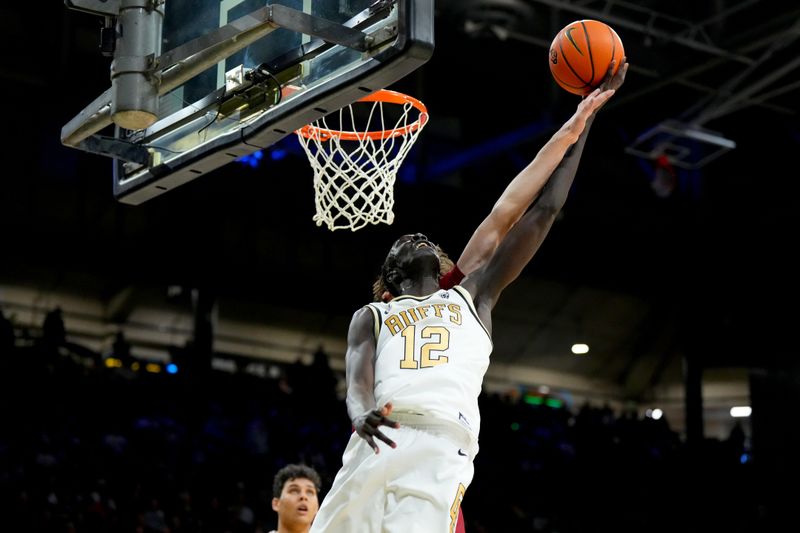 Mar 3, 2024; Boulder, Colorado, USA; Stanford Cardinal forward Maxime Raynaud (42) defends on Colorado Buffaloes forward Bangot Dak (12) in the second half at the CU Events Center. Mandatory Credit: Ron Chenoy-USA TODAY Sports