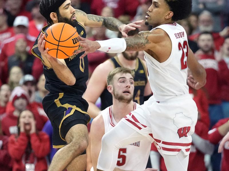 Jan 13, 2024; Madison, Wisconsin, USA; Wisconsin Badgers guard Chucky Hepburn (23) tips a pass by Northwestern Wildcats guard Boo Buie (0) during the second half at the Kohl Center. Mandatory Credit: Kayla Wolf-USA TODAY Sports