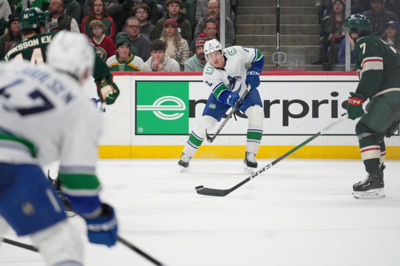 Feb 19, 2024; Saint Paul, Minnesota, USA; Vancouver Canucks center J.T. Miller (9) passes to defenseman Noah Juulsen (47) against the Minnesota Wild in the third period at Xcel Energy Center. Mandatory Credit: Matt Blewett-USA TODAY Sports