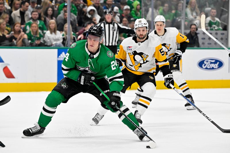 Mar 22, 2024; Dallas, Texas, USA; Dallas Stars center Roope Hintz (24) skates with the puck past Pittsburgh Penguins right wing Emil Bemstrom (52) during the second period at the American Airlines Center. Mandatory Credit: Jerome Miron-USA TODAY Sports