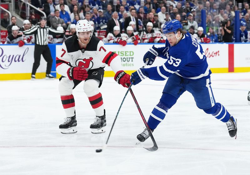 Dec 30, 2025; Toronto, Ontario, CAN; Toronto Maple Leafs right wing Easton Cowan (53) shoots against New Jersey Devils defenseman Dougie Hamilton (7) during the third period at Scotiabank Arena. Mandatory Credit: Nick Turchiaro-Imagn Images