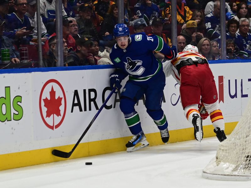 Mar 23, 2024; Vancouver, British Columbia, CAN; Vancouver Canucks forward Nils Hoglander (21) controls the puck against the Calgary Flames during the first period at Rogers Arena. Mandatory Credit: Simon Fearn-USA TODAY Sports