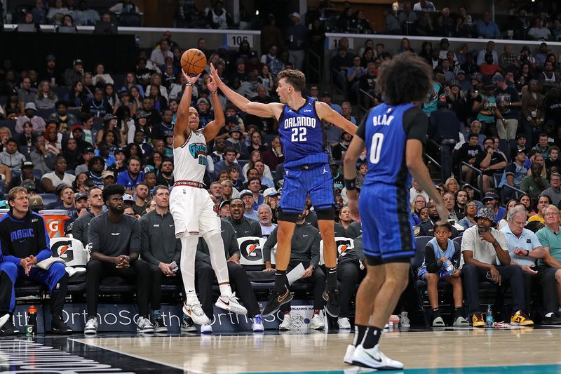 MEMPHIS, TENNESSEE - OCTOBER 26: Desmond Bane #22 of the Memphis Grizzlies shoots against Franz Wagner #22 of the Orlando Magic during the second half at FedExForum on October 26, 2024 in Memphis, Tennessee. NOTE TO USER: User expressly acknowledges and agrees that, by downloading and or using this photograph, User is consenting to the terms and conditions of the Getty Images License Agreement. (Photo by Justin Ford/Getty Images)