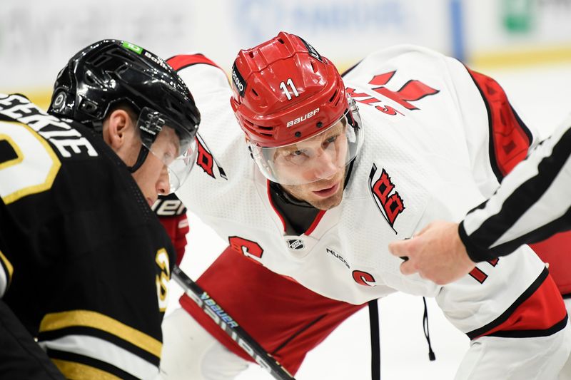 Apr 9, 2024; Boston, Massachusetts, USA; Carolina Hurricanes center Jordan Staal (11) gets set for a face off against Boston Bruins center Morgan Geekie (39) during the second period at TD Garden. Mandatory Credit: Bob DeChiara-USA TODAY Sports