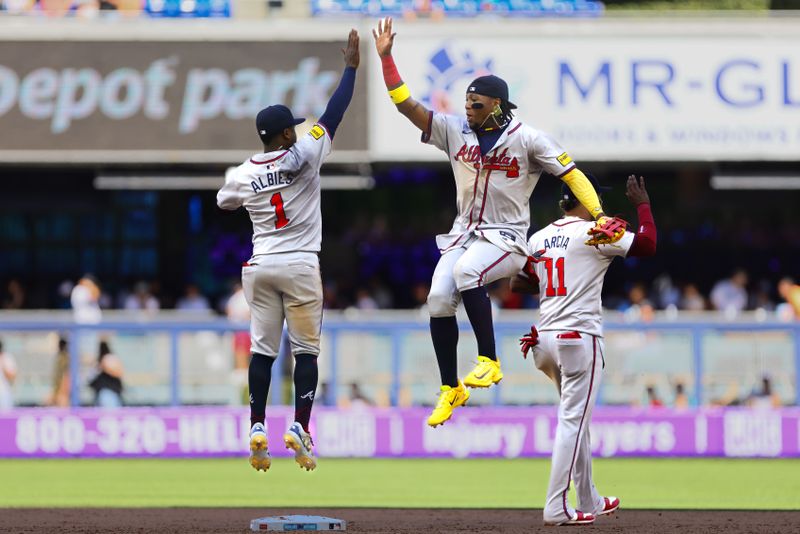 Apr 14, 2024; Miami, Florida, USA; Atlanta Braves right fielder Ronald Acuna Jr. (13) celebrates with Atlanta Braves second baseman Ozzie Albies (1) after the game against the Miami Marlins at loanDepot Park. Mandatory Credit: Sam Navarro-USA TODAY Sports