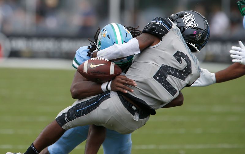 Oct 24, 2020; Orlando, Florida, USA; Tulane Green Wave linebacker Dorian Williams (24) hits UCF Knights running back Otis Anderson (2) during the first quarter at the  Bounce House. Mandatory Credit: Reinhold Matay-USA TODAY Sports