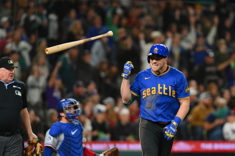 Sep 14, 2024; Seattle, Washington, USA; Seattle Mariners left fielder Luke Raley (20) flips his bat after hitting a 2-run home run against the Texas Rangers during the fifth inning at T-Mobile Park. Mandatory Credit: Steven Bisig-Imagn Images