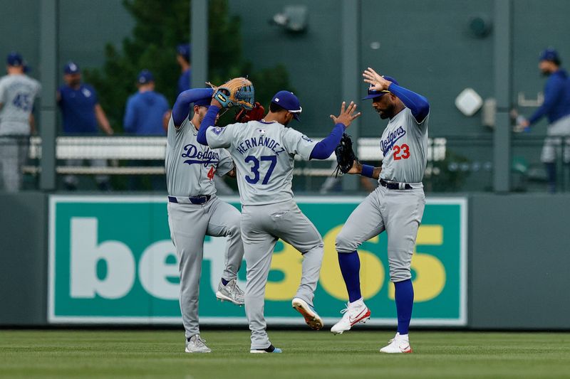 Jun 20, 2024; Denver, Colorado, USA; Los Angeles Dodgers center fielder Andy Pages (44) and right fielder Teoscar Hernandez (37) and outfielder Jason Heyward (23) celebrate after the game against the Colorado Rockies at Coors Field. Mandatory Credit: Isaiah J. Downing-USA TODAY Sports