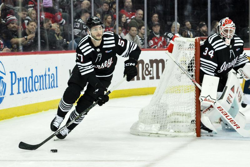 Apr 7, 2024; Newark, New Jersey, USA; New Jersey Devils defenseman Nick DeSimone (57) skates with the puck during the first period against the Nashville Predators at Prudential Center. Mandatory Credit: John Jones-USA TODAY Sports