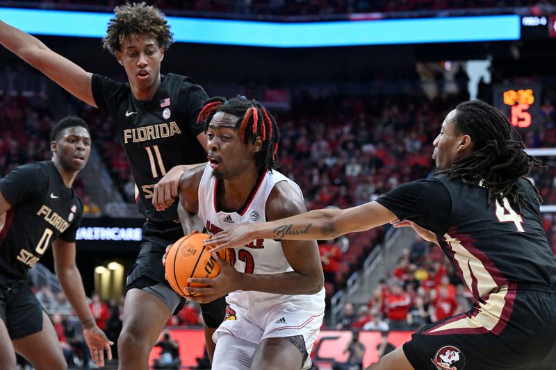 Feb 4, 2023; Louisville, Kentucky, USA;  Louisville Cardinals forward Kamari Lands (22) drives to the basket against Florida State Seminoles forward Baba Miller (11) and guard Caleb Mills (4) during the second half at KFC Yum! Center. Florida State defeated Louisville 81-78. Mandatory Credit: Jamie Rhodes-USA TODAY Sports