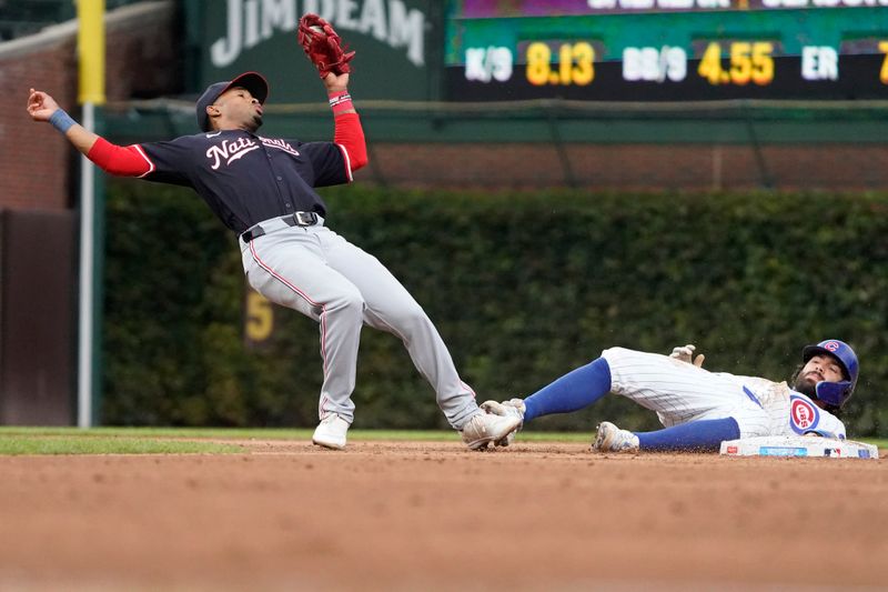 Sep 22, 2024; Chicago, Illinois, USA; Chicago Cubs shortstop Dansby Swanson (7) is picked-off of second base as Washington Nationals shortstop Nasim Nuñez (26) takes the throw during the seventh inning at Wrigley Field. Mandatory Credit: David Banks-Imagn Images