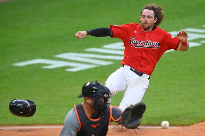 Jul 23, 2024; Cleveland, Ohio, USA; Cleveland Guardians shortstop Daniel Schneemann (10) scores beside Detroit Tigers catcher Jake Rogers (34) in the sixth inning at Progressive Field. Mandatory Credit: David Richard-USA TODAY Sports