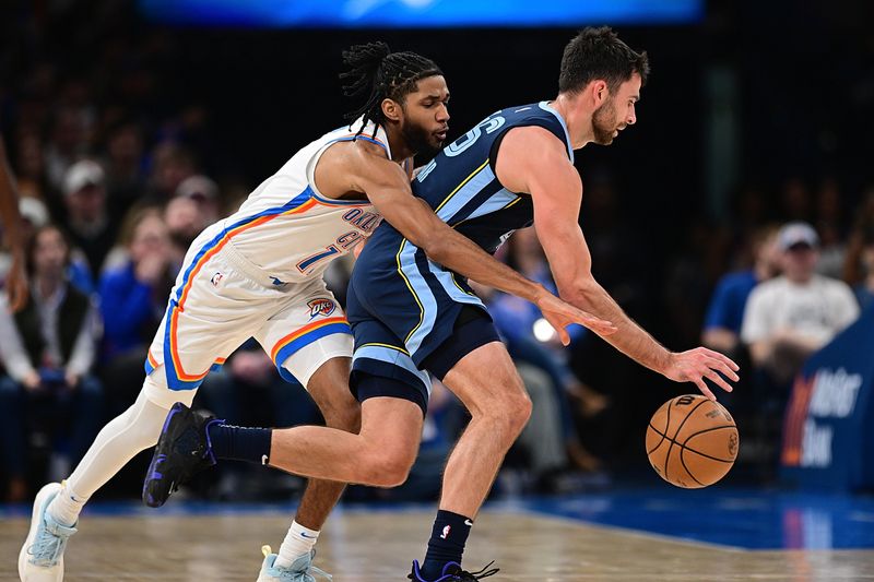 OKLAHOMA CITY, OKLAHOMA - DECEMBER 18: Isaiah Joe #11 of the Oklahoma City Thunder goes for the ball around John Konchar #46 of the Memphis Grizzlies during the second half at Paycom Center on December 18, 2023 in Oklahoma City, Oklahoma. NOTE TO USER: User expressly acknowledges and agrees that, by downloading and or using this Photograph, user is consenting to the terms and conditions of the Getty Images License Agreement. (Photo by Joshua Gateley/Getty Images)