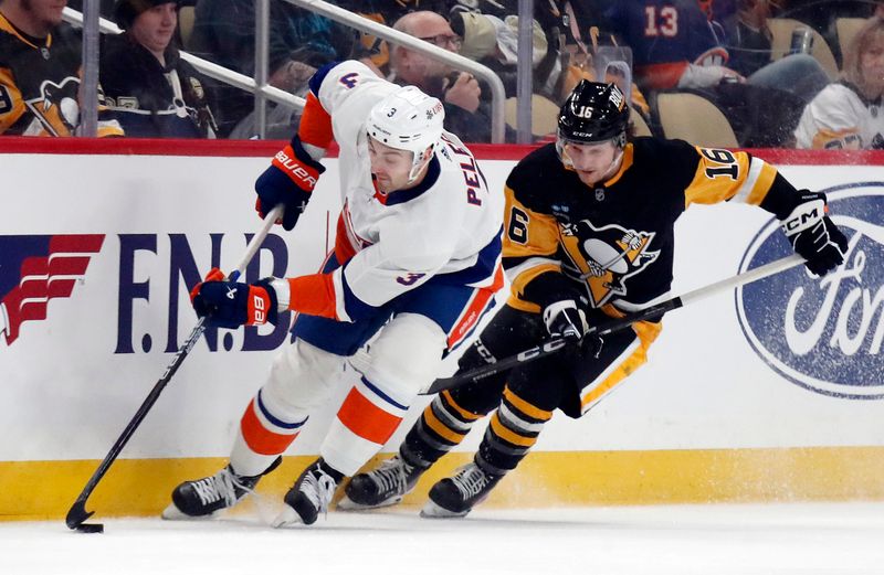 Feb 20, 2024; Pittsburgh, Pennsylvania, USA; New York Islanders defenseman Adam Pelech (3) moves the puck against Pittsburgh Penguins right wing Matthew Phillips (16) during the first period at PPG Paints Arena. Mandatory Credit: Charles LeClaire-USA TODAY Sports