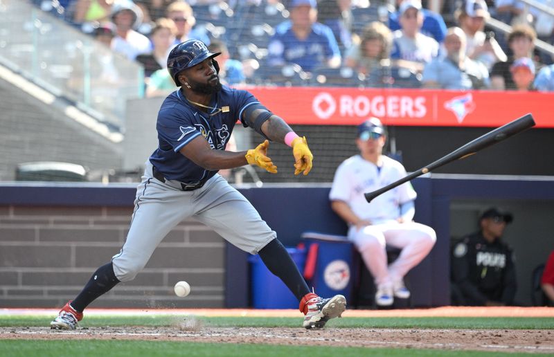 Jul 25, 2024; Toronto, Ontario, CAN; Tampa Bay Rays left fielder Randy Arozarena (56) loses his grip on his bat as he fouls a pitch off against the Toronto Blue Jays in the seventh inning at Rogers Centre. Mandatory Credit: Dan Hamilton-USA TODAY Sports