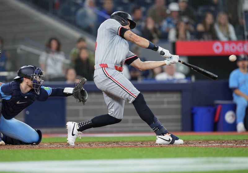 May 11, 2024; Toronto, Ontario, CAN; Minnesota Twins right fielder Max Kepler (26) hits a single against the Toronto Blue Jays during the ninth inning at Rogers Centre. Mandatory Credit: Nick Turchiaro-USA TODAY Sports