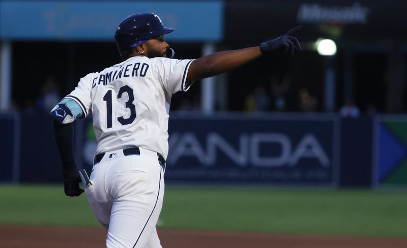 Jun 30, 2025; Tampa, Florida, USA;  Tampa Bay Rays third base Junior Caminero (13) hits a two-run home run against the Athletics during the fourth inning at George M. Steinbrenner Field. Mandatory Credit: Kim Klement Neitzel-Imagn Images