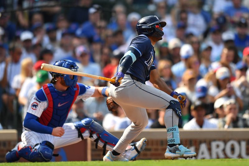 Sep 13, 2025; Chicago, Illinois, USA; Tampa Bay Rays left fielder Richie Palacios (1) hits a sacrifice RBI against the Chicago Cubs during the fifth inning at Wrigley Field. Mandatory Credit: Patrick Gorski-Imagn Images