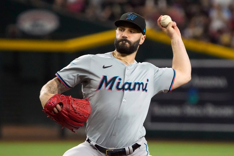 May 26, 2024; Phoenix, Arizona, USA; Miami Marlins pitcher Tanner Scott (66) throws against the Arizona Diamondbacks in the ninth inning at Chase Field. Mandatory Credit: Rick Scuteri-USA TODAY Sports