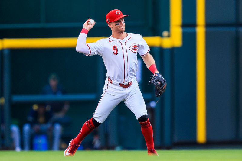 Aug 16, 2025; Cincinnati, Ohio, USA; Cincinnati Reds second baseman Matt McLain (9) throws to first to get Milwaukee Brewers designated hitter Christian Yelich (not pictured) out in the second inning at Great American Ball Park. Mandatory Credit: Katie Stratman-Imagn Images