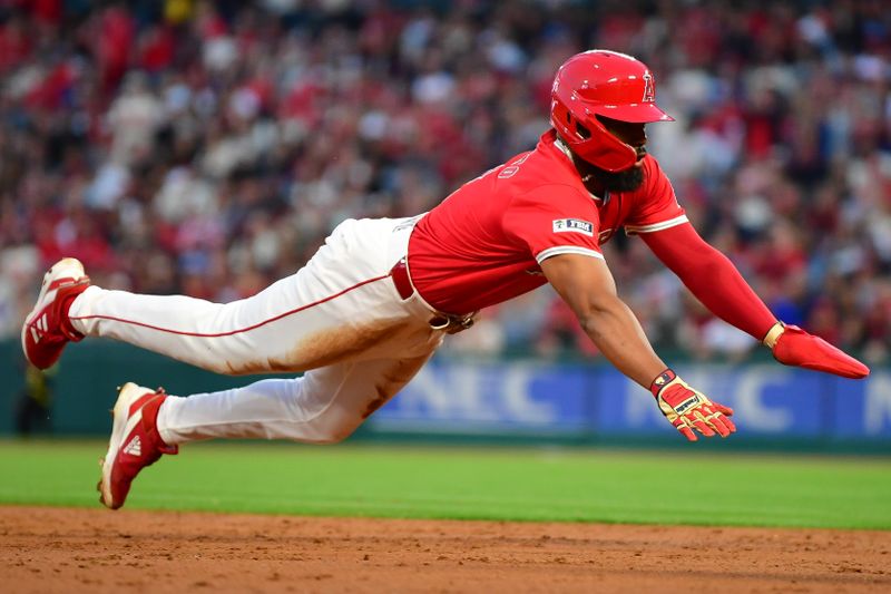 Apr 27, 2024; Anaheim, California, USA; Los Angeles Angels third baseman Luis Rengifo (2) reaches third against the Minnesota Twins during the second inning at Angel Stadium. Mandatory Credit: Gary A. Vasquez-USA TODAY Sports