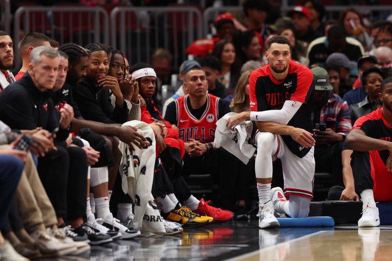 CHICAGO, ILLINOIS - OCTOBER 16: Zach LaVine #8 of the Chicago Bulls looks on from the bench against the Minnesota Timberwolves during the first half of a preseason game at the United Center on October 16, 2024 in Chicago, Illinois. NOTE TO USER: User expressly acknowledges and agrees that, by downloading and or using this photograph, User is consenting to the terms and conditions of the Getty Images License Agreement.  (Photo by Michael Reaves/Getty Images)