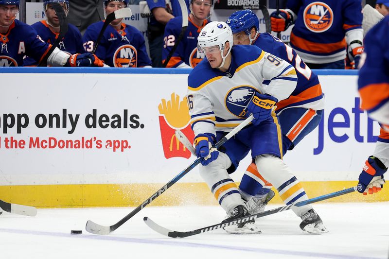 Nov 30, 2024; Elmont, New York, USA; Buffalo Sabres right wing Nicolas Aube-Kubel (96) skates with the puck against New York Islanders left wing Anders Lee (27) during the third period at UBS Arena. Mandatory Credit: Brad Penner-Imagn Images