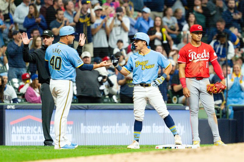 Aug 9, 2024; Milwaukee, Wisconsin, USA;  Milwaukee Brewers right fielder Sal Frelick (10) greets third base coach Jason Lane (40) after hitting a triple during the third inning inning against the Cincinnati Reds at American Family Field. Mandatory Credit: Jeff Hanisch-USA TODAY Sports