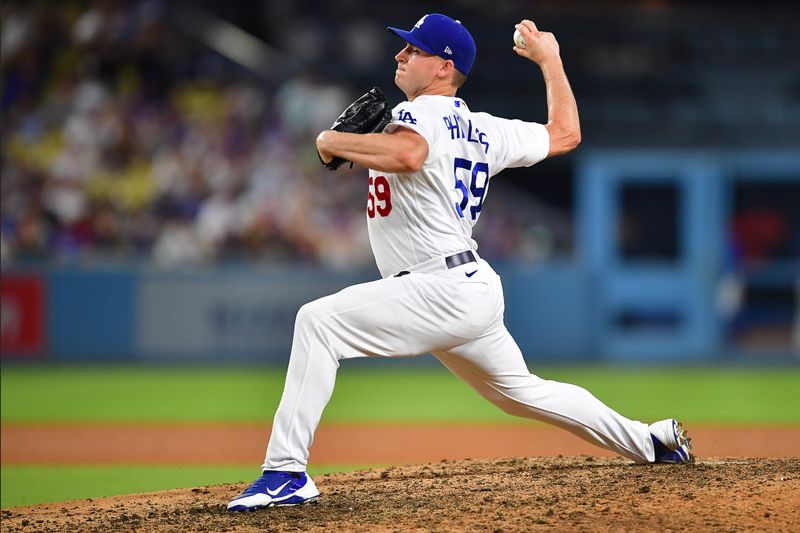 Jul 29, 2023; Los Angeles, California, USA; Los Angeles Dodgers relief pitcher Evan Phillips (59) throws against the Cincinnati Reds during the ninth inning at Dodger Stadium. Mandatory Credit: Gary A. Vasquez-USA TODAY Sports