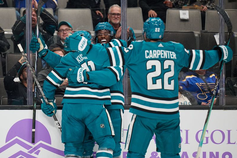 Nov 16, 2023; San Jose, California, USA; San Jose Sharks right wing Givani Smith (54) celebrates with center Luke Kunin (11) and center Ryan Carpenter (22) after scoring a goal against the St. Louis Blues during the second period at SAP Center at San Jose. Mandatory Credit: Robert Edwards-USA TODAY Sports