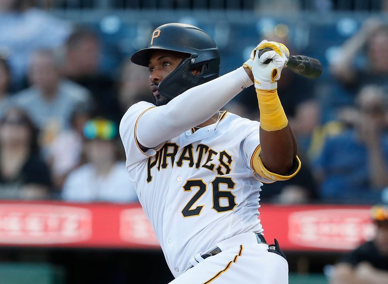 Oct 1, 2023; Pittsburgh, Pennsylvania, USA;  Pittsburgh Pirates right fielder Miguel Andujar (26) hits an RBI single against the Miami Marlins during the eighth inning at PNC Park. Pittsburgh won 3-0. Mandatory Credit: Charles LeClaire-USA TODAY Sports