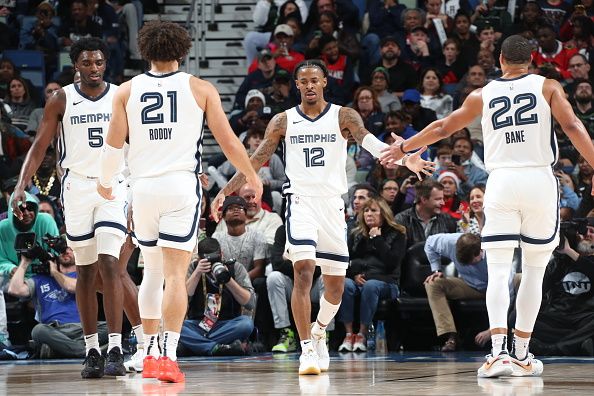 NEW ORLEANS, LA - DECEMBER 19: Ja Morant #12 high fives David Roddy #21and Desmond Bane #22 of the Memphis Grizzlies during the game against the New Orleans Pelicans on December 19, 2023 at the Smoothie King Center in New Orleans, Louisiana. NOTE TO USER: User expressly acknowledges and agrees that, by downloading and or using this Photograph, user is consenting to the terms and conditions of the Getty Images License Agreement. Mandatory Copyright Notice: Copyright 2023 NBAE (Photo by Layne Murdoch Jr./NBAE via Getty Images)