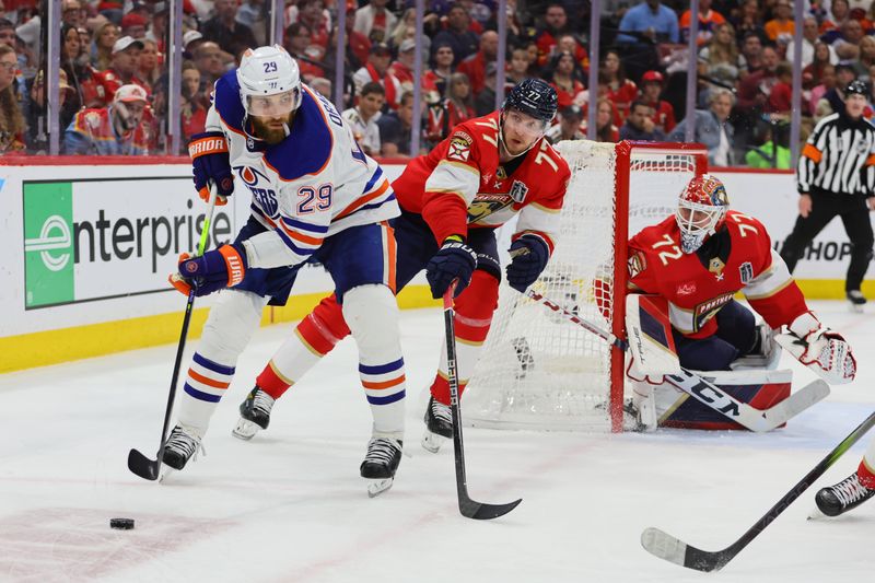 Jun 24, 2024; Sunrise, Florida, USA; Edmonton Oilers forward Leon Draisaitl (29) controls the puck against Florida Panthers defenseman Niko Mikkola (77) during the third period in game seven of the 2024 Stanley Cup Final at Amerant Bank Arena. Mandatory Credit: Sam Navarro-USA TODAY Sports